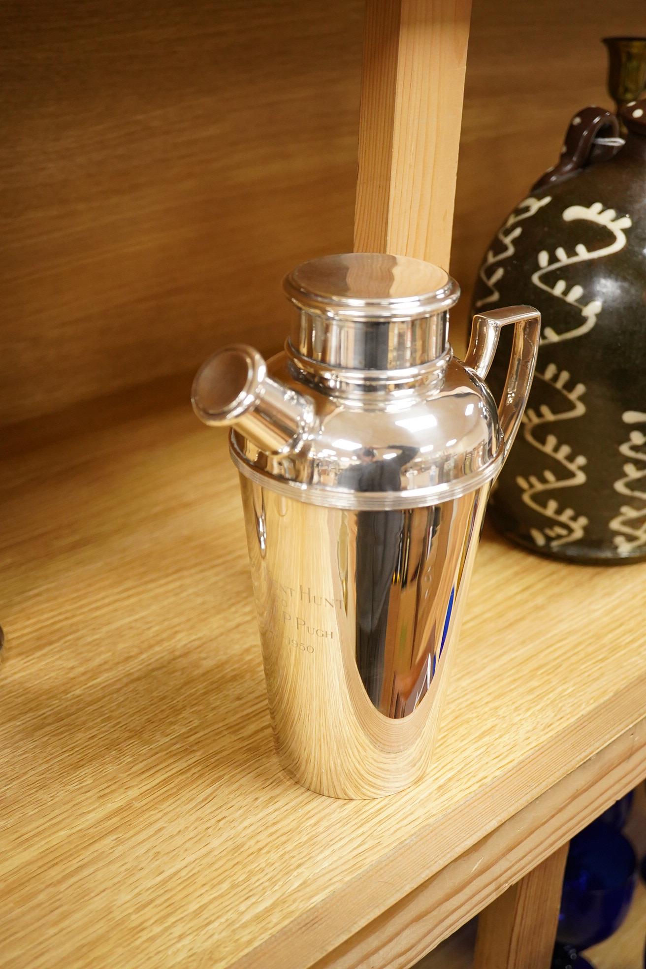 A mid 20th century silver plated patent cocktail shaker with recipes, two other cocktail shakers and an ice bucket, largest 28cm high